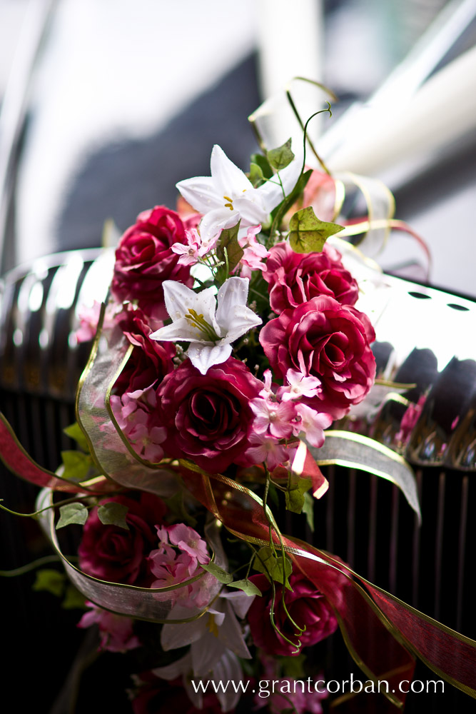 Pretty flowers make a nice hood ornament on the wedding car at St Johns Cathedral