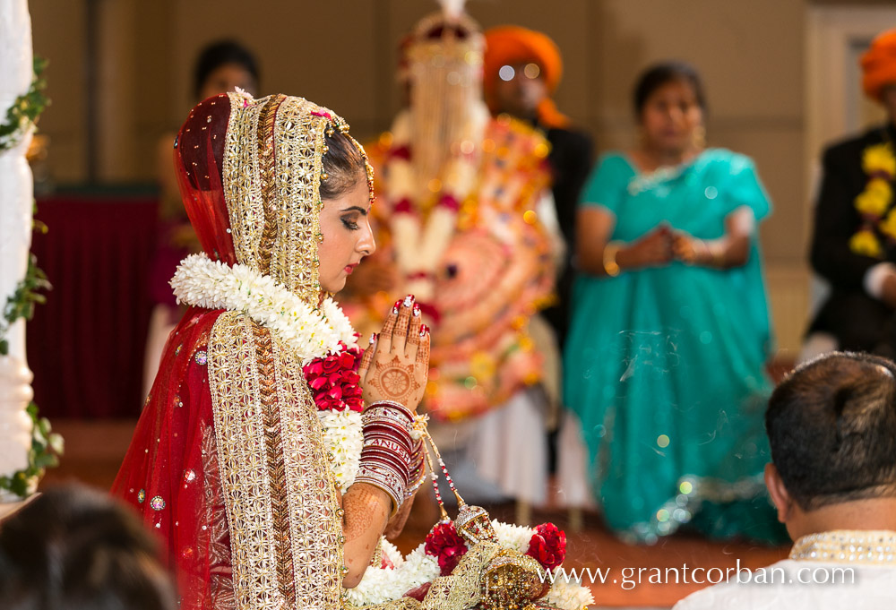 Bride praying at punjabi wedding in MITC